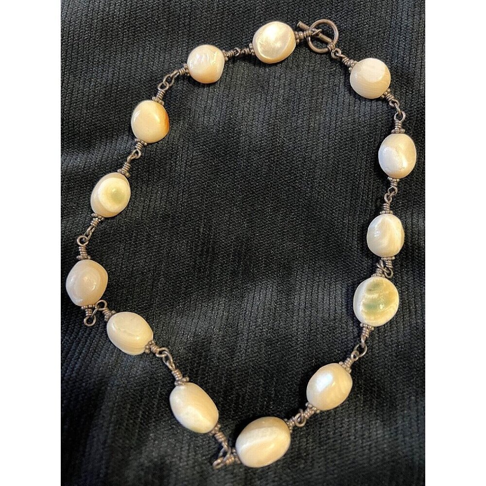 Shiva Eye Shell Necklace with sterling silver wire. Unique spherical beads.​